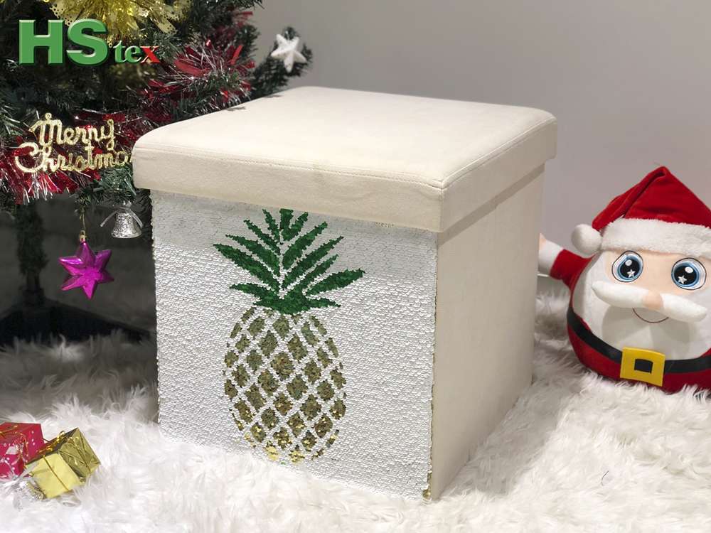 Foldable storage ottoman with reversible plastic scale pineapple pattern